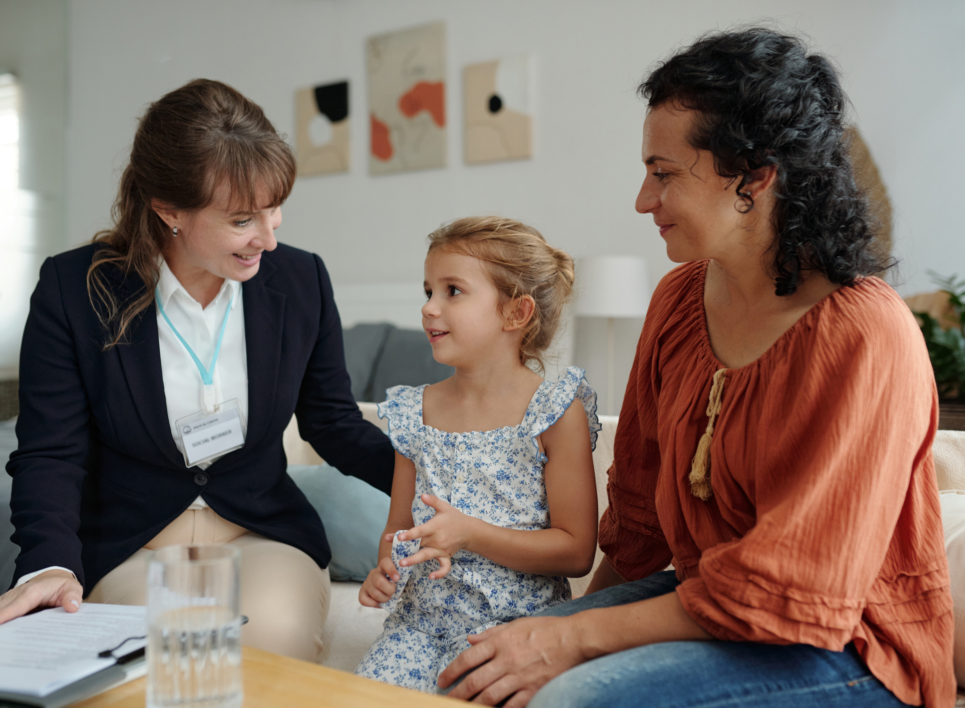 Parent and child with therapist after autism treatment